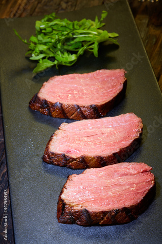 Sous-vide steak cut into pieces, cooked to eat beef on the stone table photo