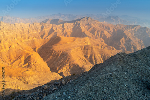 view to waves of mountains peaks in golden hour in UAE