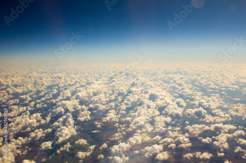 White clouds in blue sky. Aerial view from airplane.