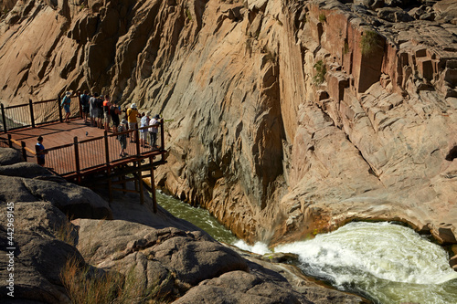 Tourists on viewing platform looking at Augrabies Falls on Orange River Augrabies Falls National Park Northern Cape South Africa photo