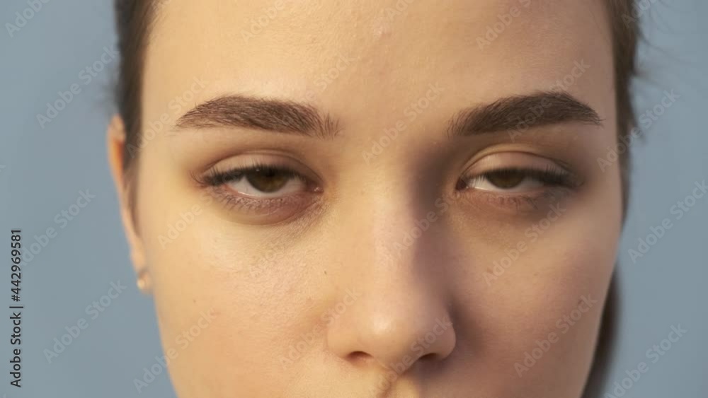 Close-up face of a young woman, brown-haired woman, long straight hair, beautiful skin tone Close-up face of a young woman, brown-haired woman, long straight hair, beautiful skin tone