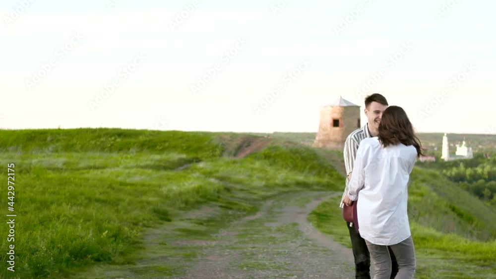 Young couple in love are spinning and having fun outdoors. Slow motion. Young couple in love are spinning and having fun outdoors. Slow motion.