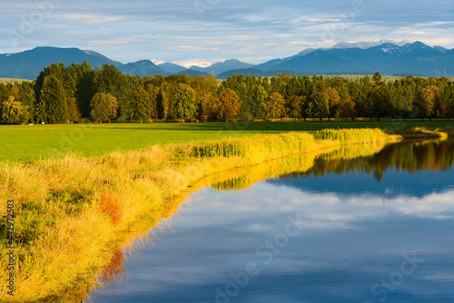 Sunset over Sikes Lake in the Snoqualmie Valley as the shoreline reflects in the calm surface of the water
 photo