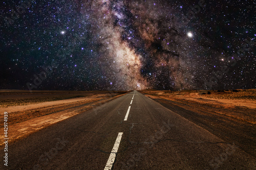 Milky Way over an empty road. Road to infinity.