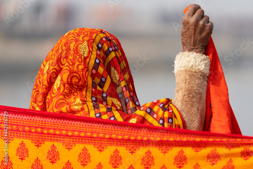 India Uttar Pradesh Allahabad Prayagraj Ardh Kumbh Mela. A woman is dressed in colorful saffron material. photo