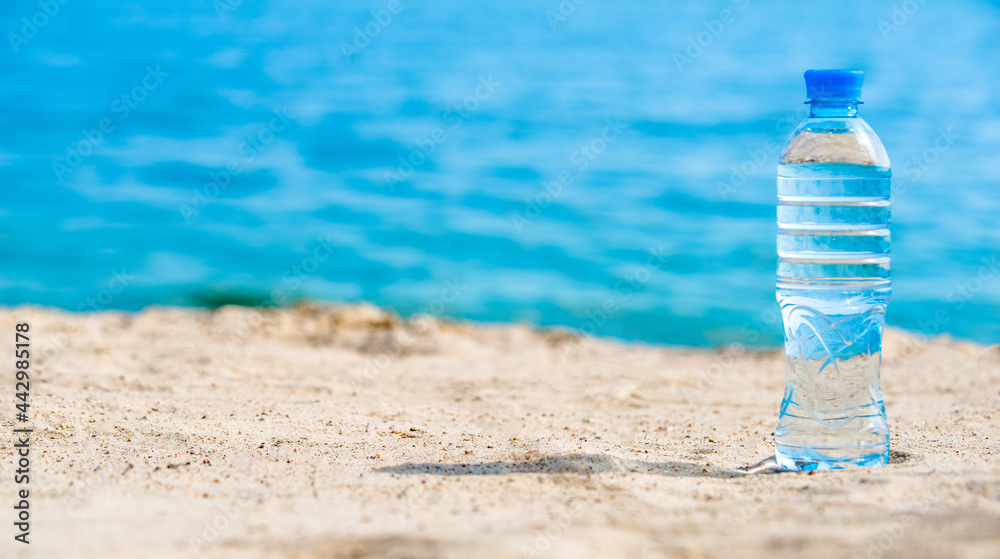 A bottle of drinking water on the sea beach A bottle of drinking water on the sea beach