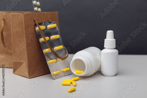Bags with compounded prescription medications shipped from a mail order pharmacy on a grey background photo