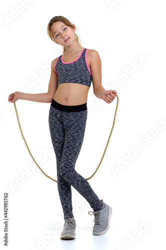 Girl performing exercise with jumping rope.