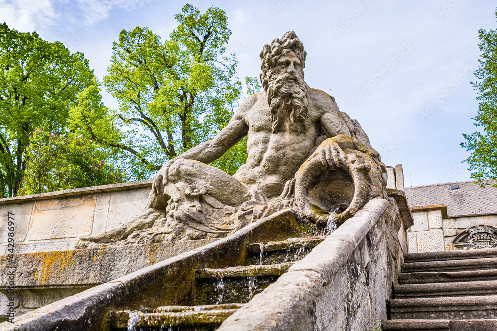 Kuks, Czech republic - May 15, 2021. Steps with water cascade and statue of Triton - greek god of the sea - on both side of stairs