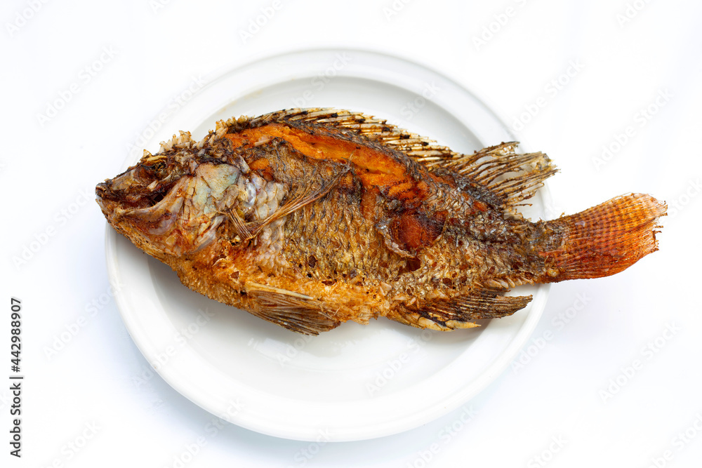 Fried fish in white plate on white background. Fried fish in white plate on white background.