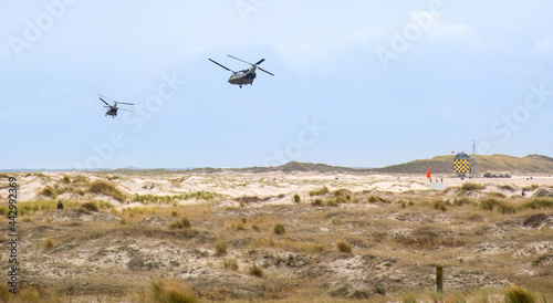 Chinook helicopters flying over the dunes