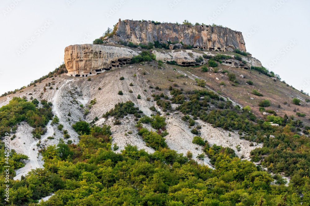 Tepe-Kermen is an ancient cave town in Crimea. Scenic sunny day landscape.