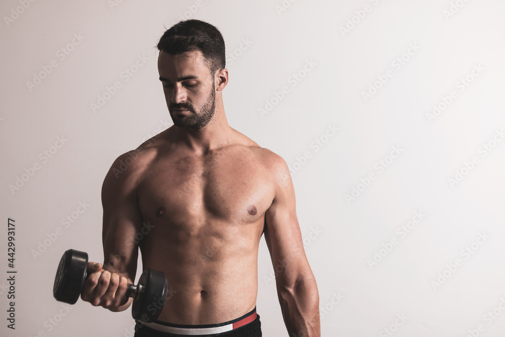 a handsome and muscular guy posing on a white background