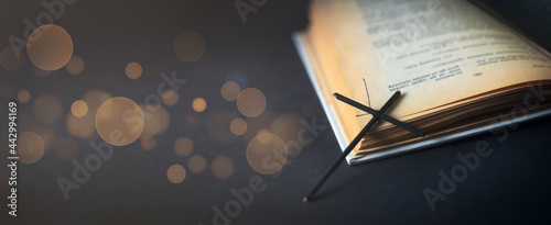 Open bible and cross. An open book. Copy space.	 photo