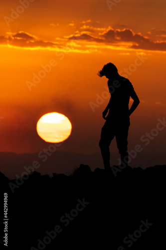 silhouette of a man on the mountain at sunset
