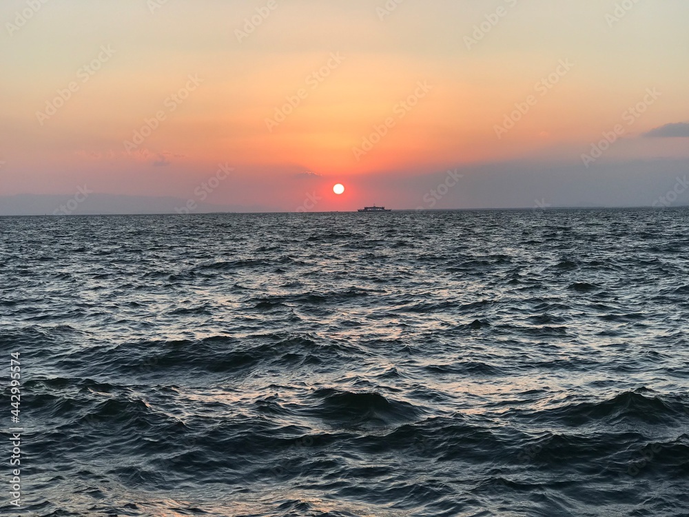 Fototapeta premium sunset and the ferry crossing the bay