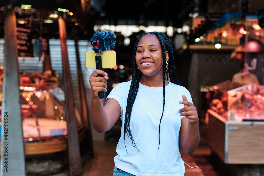 young latin influencer at local market streaming for her fans