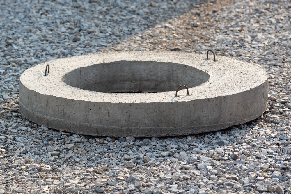 Reinforced concrete manhole cover for the well.