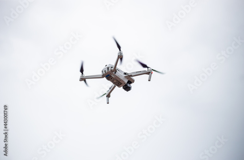 Fototapeta Naklejka Na Ścianę i Meble -  Modern drone with video camera in the air against the background of the sky