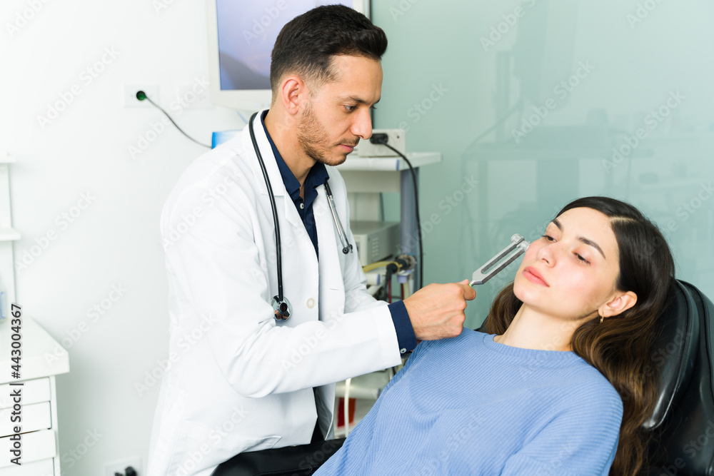 Specialist examining the ears of a latin woman Specialist examining the ears of a latin woman