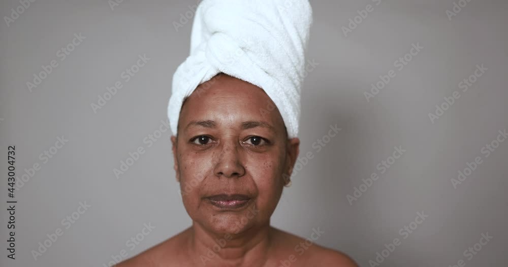 Mature african woman looking serious on camera - Beauty day, skin care therapy and real people concept Mature african woman looking serious on camera - Beauty day, skin care therapy and real people concept