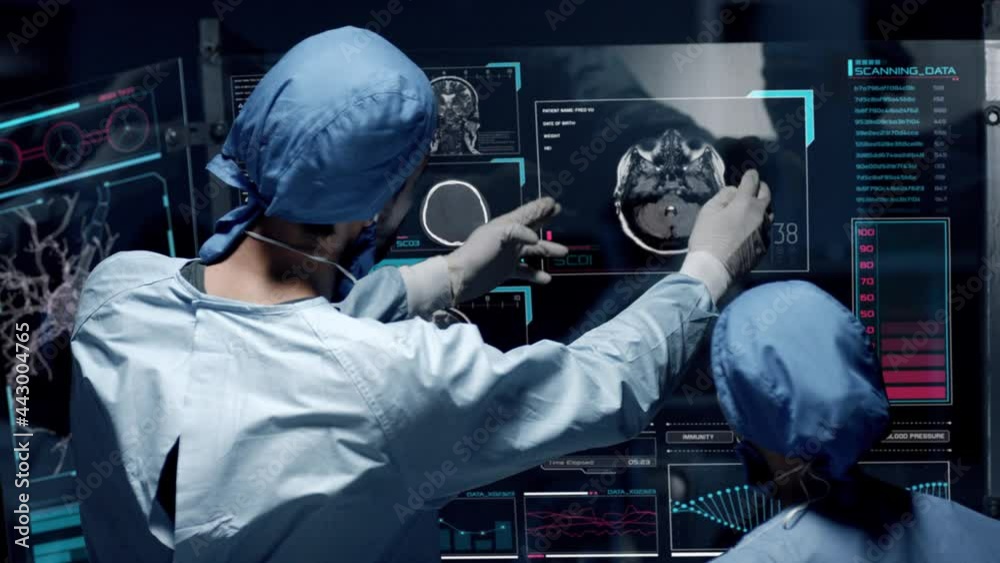Professional doctors analyzing patient's medical MRI diagnosis by checking on a large glass screen with futuristic holograms. Concept of: medicine, doctors, future, holographic, brain scan