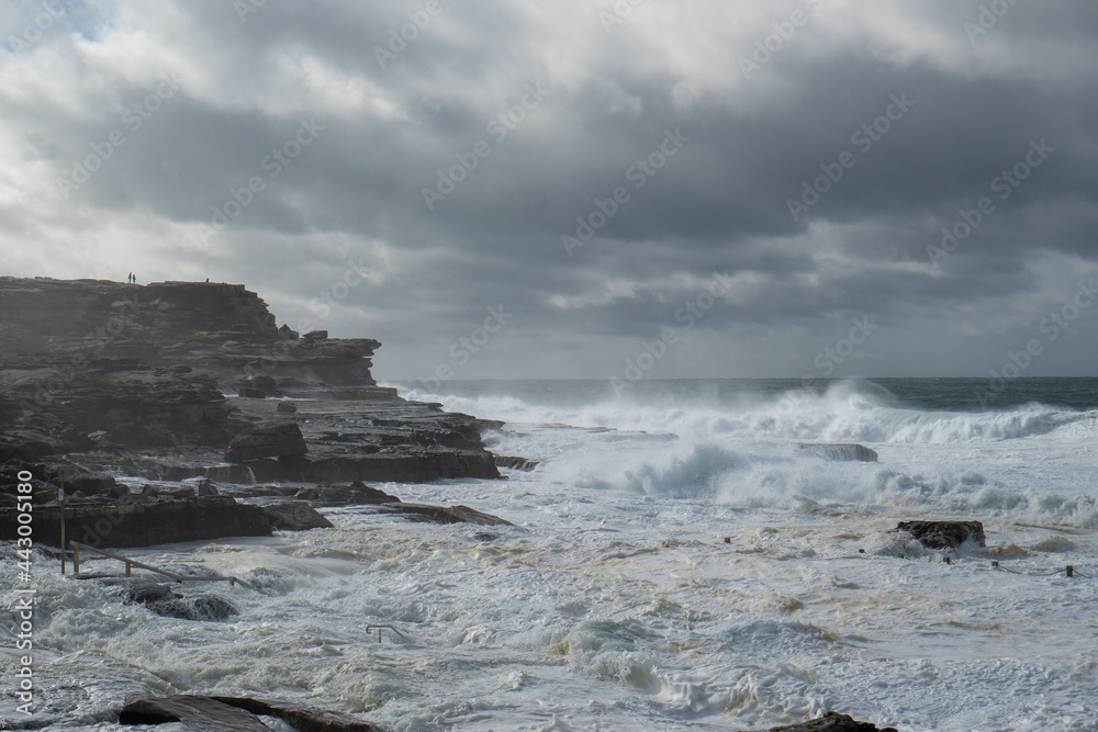 stormy and big wild waves over ocean pool 