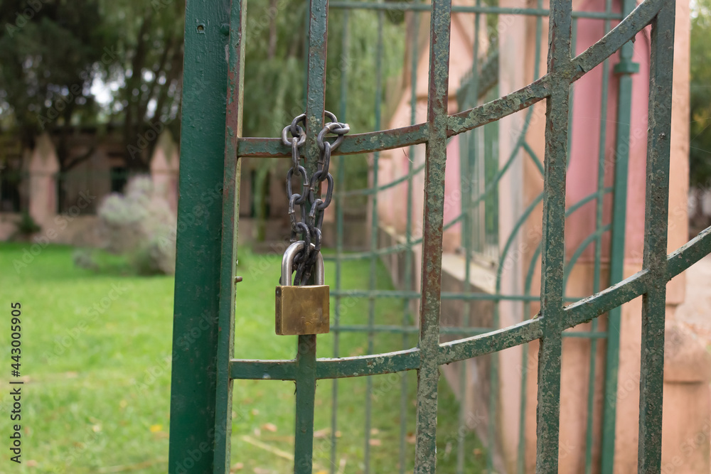 Rusty gate with a chain and a padlock. Rusty gate with a chain and a padlock.