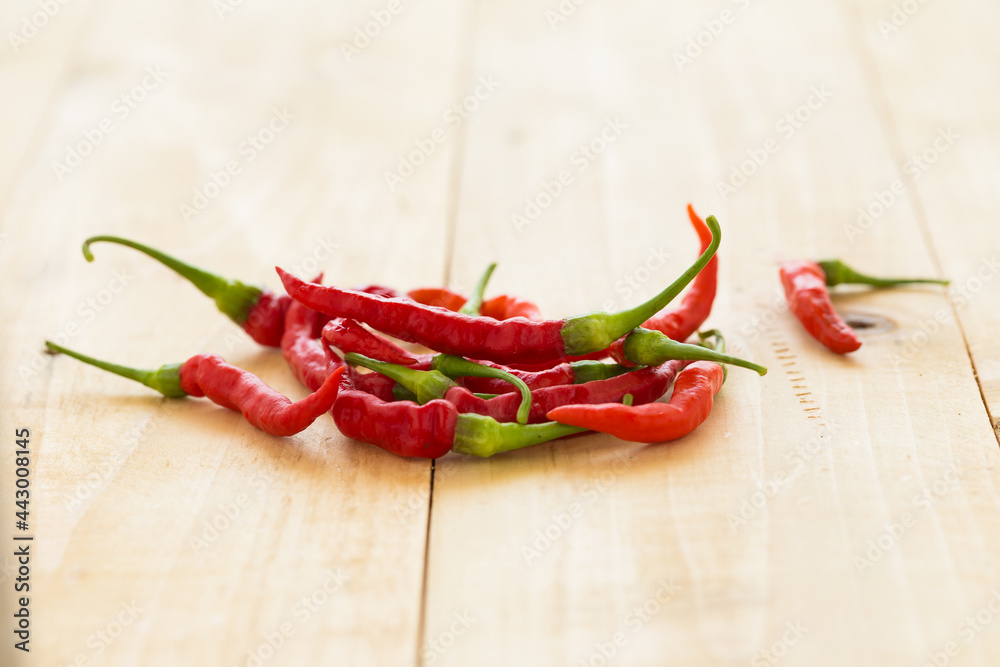 Red hot chili peppers on wooden background. Spicy chilli peppers