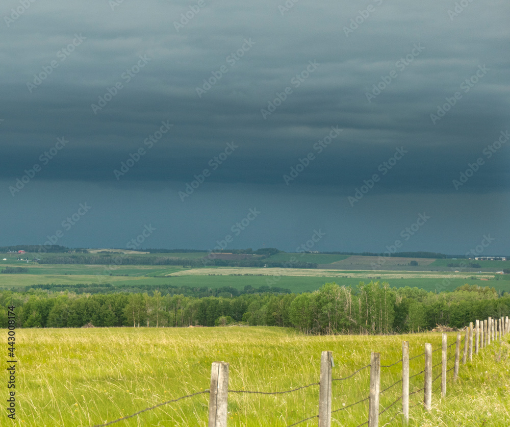 landscape with fence and stormy sky