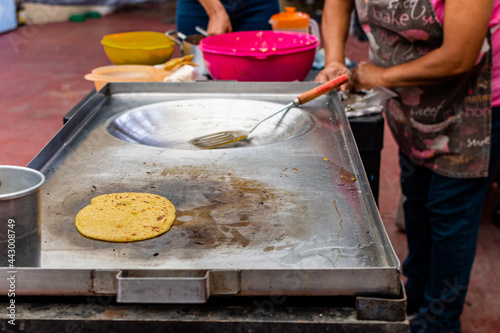 woman's hand preparing a typical mexican food as a quesadillas, sopes, huaraches and more photo