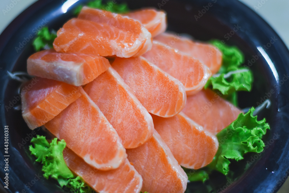 Delicious orange salmon fillet with vegetables in a plate.