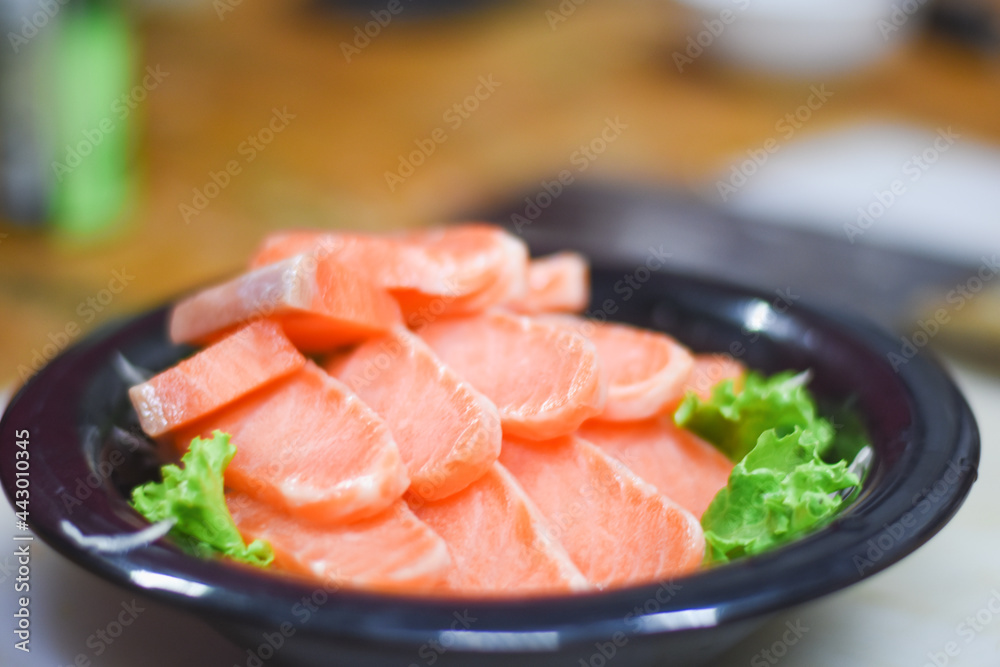 Delicious orange salmon fillet with vegetables in a plate.