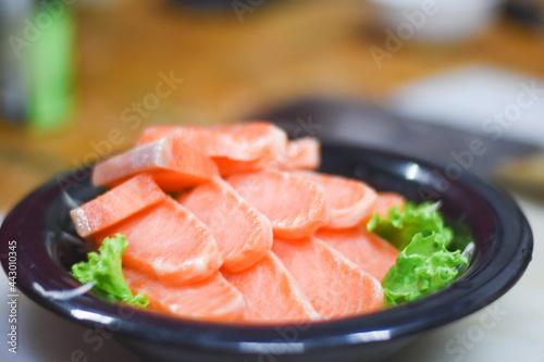 Delicious orange salmon fillet with vegetables in a plate.