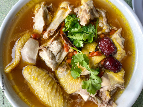 Chinese chicken goji berry clear broth soup healthy medicinal in bowl photo