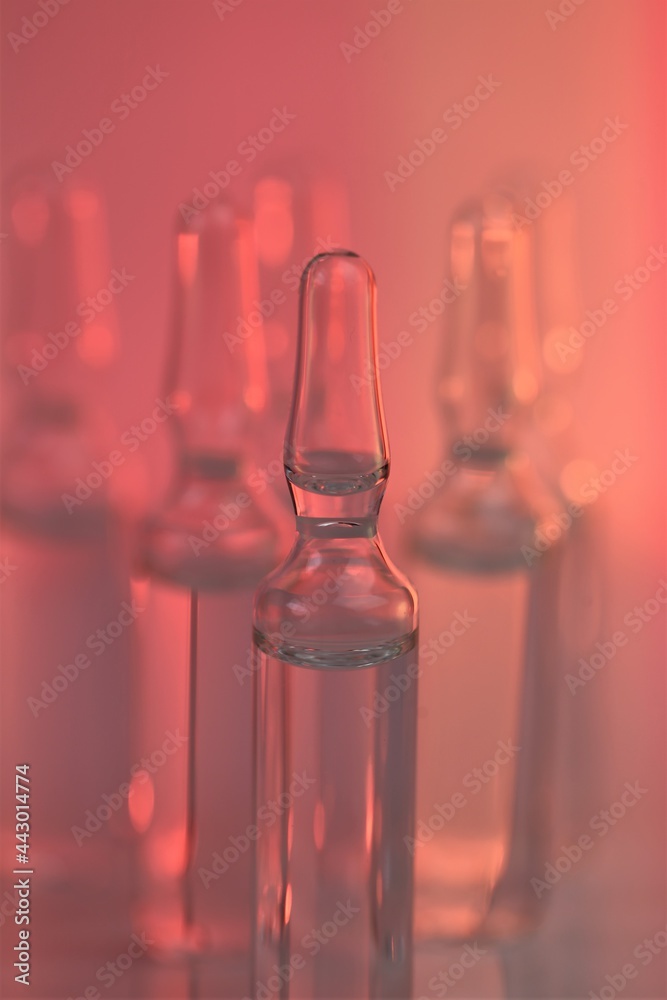 Medicine and Pharmacology.Transparent glass apmules in pink light. Biotechnology and Science.vaccination  and medicine. biorevitalization treatment, mesotherapy solution.  solution for injection. 