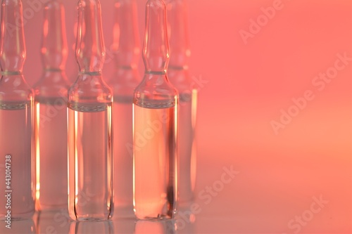 biorevitalization treatment, mesotherapy solution.  solution for injection. Medicine and Pharmacology.Transparent glass apmules in pink light. 