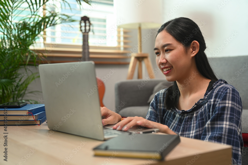 Smiling young woman working with computer laptop at home. Smiling young woman working with computer laptop at home.
