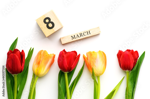 Yellow and red tulips and the inscription on March 8 isolated on white background. Spring and summer backdrop. International Women's Day photo