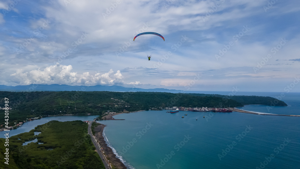 Beautiful aerial view of the extreme sport of paragliding on the Beach and mountains of Costa Rica Beautiful aerial view of the extreme sport of paragliding on the Beach and mountains of Costa Rica