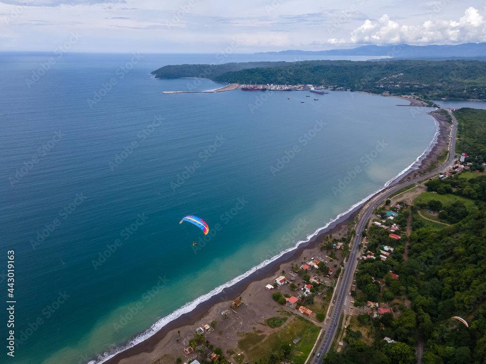 Beautiful aerial view of the extreme sport of paragliding on the Beach and mountains of Costa Rica 