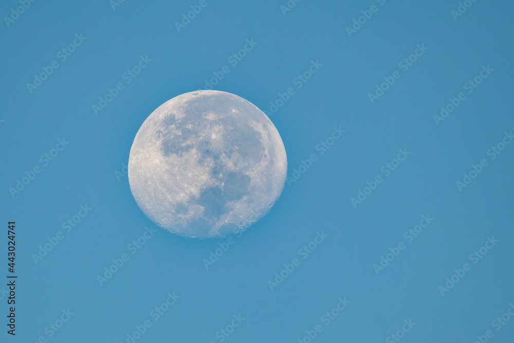 view of full moon and blue sky