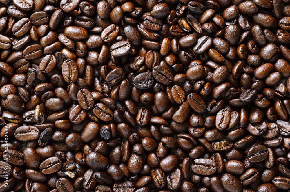 Obraz premium Roasted full coffee beans close-up. Coffee background. Top view, flat lay.