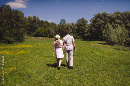 couple girl and guy photo from the back. love story couple walking in nature