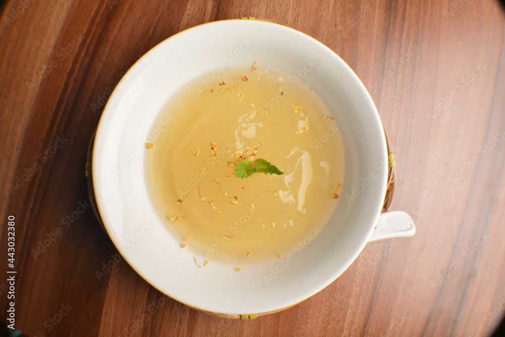 chilled sweet lemongrass jelly pudding with gui hua flower dessert in bowl on wood table asian dessert halal menu chilled sweet lemongrass jelly pudding with gui hua flower dessert in bowl on wood table asian dessert halal menu