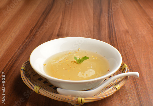 chilled sweet lemongrass jelly pudding with gui hua flower dessert in bowl on wood table asian dessert halal menu