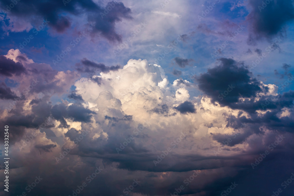 Beautiful dramatic clouds on a background of blue sky before the summer storm. Powerful sky background with a big cloud