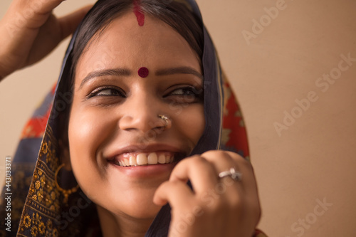 Slika na platnu A RURAL WOMAN LAUGHING WHILE COVERING HER HEAD