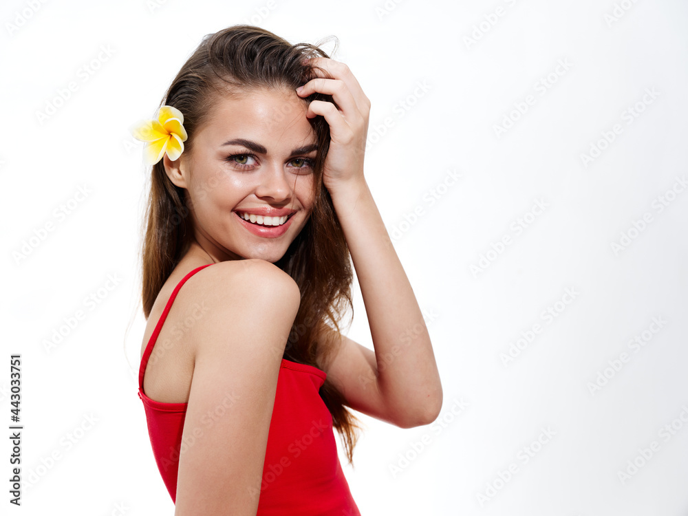 happy brunette in a red t-shirt with a flower in her hair smile model