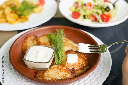 Potato pancakes with sour cream and herbs